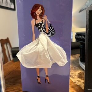 Tissue box, lady in purple.